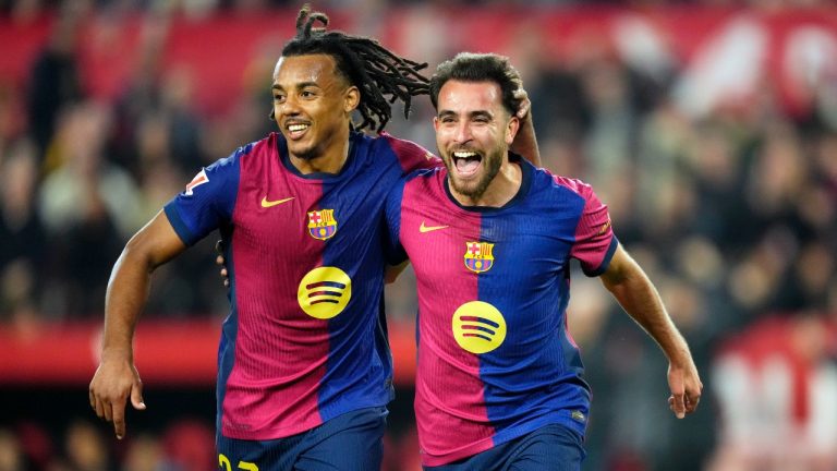 Barcelona's Eric Garcia celebrates with Jules Kounde, left, after scoring his side's fourth goal during a Spanish La Liga soccer match between Sevilla and FC Barcelona at the Ramon Sanchez Pizjuan stadium in Seville, Spain, Sunday, Feb. 9, 2025. (Jose Breton/AP)
