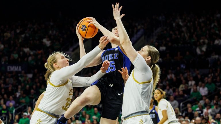 Duke forward Toby Fournier (35) shoots as Notre Dame forward Liza Karlen, left, and Notre Dame forward Kate Koval, right, defend during the second half of an NCAA college basketball game Monday, Feb. 17, 2025, in South Bend, Ind. (John Mersits/AP Photo)