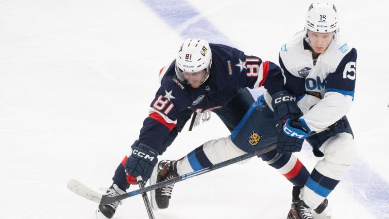 United States' Kyle Connor (81) and Finland's Anton Lundell (15) battle for the puck during second period 4 Nations Face-Off hockey action in Montreal on Thursday, Feb. 13, 2025. (Christinne Muschi/CP)