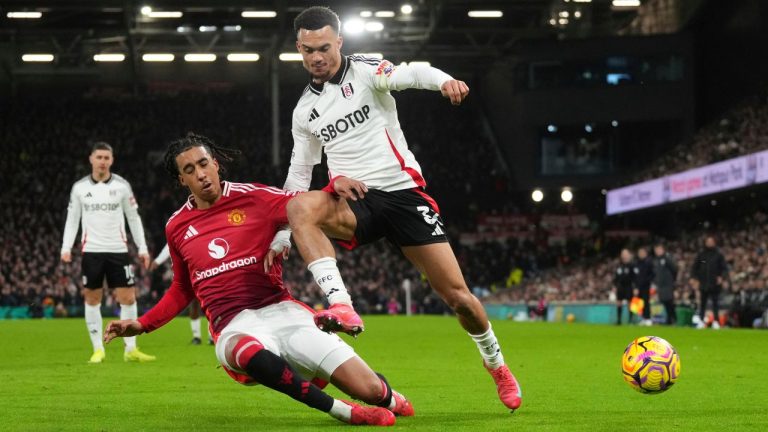 Fulham's Antonee Robinson, right, and Manchester United's Leny Yoro vie for the ball during the English Premier League soccer match between Fulham and Manchester United at Craven Cottage stadium in London, Sunday, Jan. 26, 2025. (Kirsty Wigglesworth/AP)