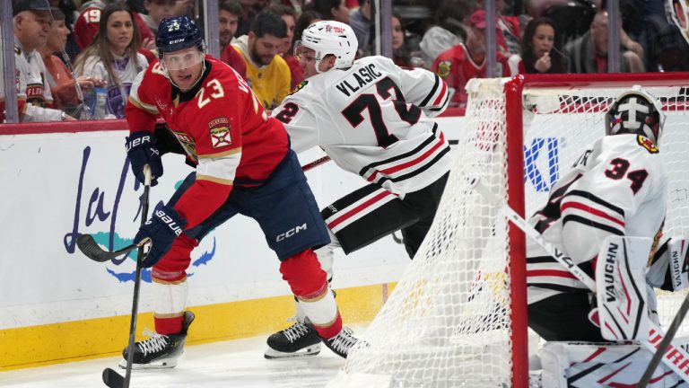 Florida Panthers center Carter Verhaeghe (23) skates with the puck as Chicago Blackhawks defenseman Alex Vlasic (72) defends during the second period of an NHL hockey game, Saturday, Feb. 1, 2025, in Sunrise, Fla. (Lynne Sladky/AP)