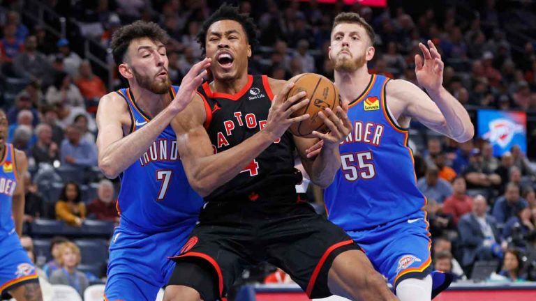 Toronto Raptors forward Scottie Barnes, center, goes to the basket as Oklahoma City Thunder forward Chet Holmgren (7) and center Isaiah Hartenstein (55) defend during the second half of an NBA basketball game. (Nate Billings/AP)