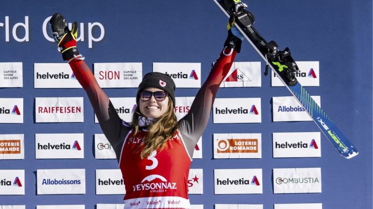India Sherret, of Cranbrook, B.C. celebrates on the podium after the women's Ski Cross event at the FIS Ski Cross, SX, World Cup, in Veysonnaz, Switzerland, Saturday, Feb. 1, 2025. (Jean-Christophe Bott/Keystone via AP)

