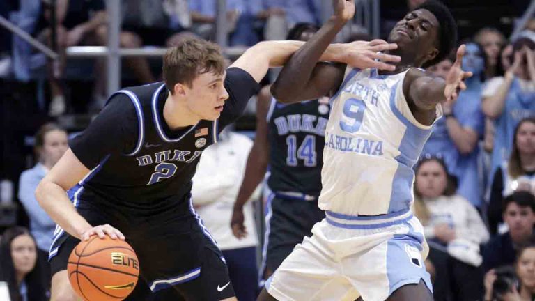 Duke forward Cooper Flagg (2) was called for a foul as he pushes North Carolina guard Drake Powell (9) during the first half of an NCAA college basketball game Saturday, March 8, 2025, in Chapel Hill, N.C. (Chris Seward/AP)