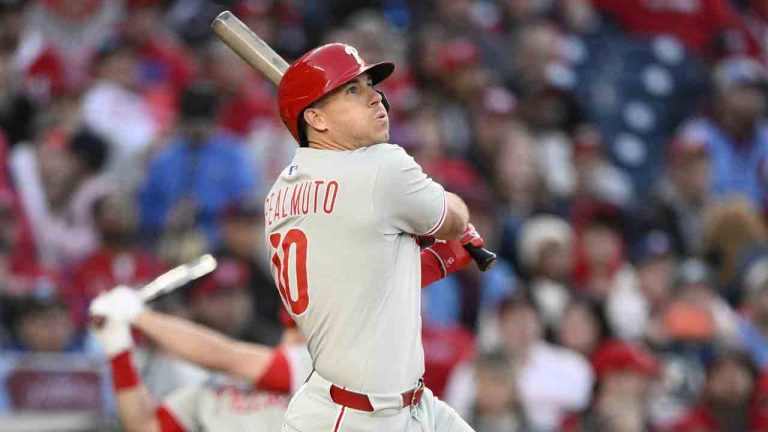Philadelphia Phillies' J.T. Realmuto follows through on his 2 RBI triple in the 10th inning of an opening-day baseball game against the Washington Nationals, Thursday, March 27, 2025, in Washington. (Nick Wass/AP)