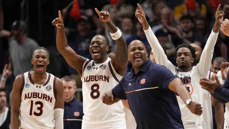The Auburn bench celebrates during the second half in the Sweet 16 of the NCAA college basketball tournament against Michigan, Saturday, March 29, 2025, in Atlanta. (George Walker IV/AP)