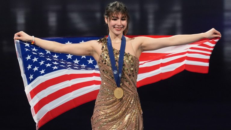 Gold medalist Alysa Liu, of the United States poses for photos during a medal ceremony for the women's free skating program at the figure skating world championships, Friday, March 28, 2025, in Boston. (AP Photo/Charles Krupa)
