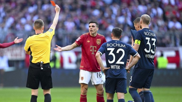 Bayern's Joao Palhinha is shown a red card by referee Christian Dingert during the German Bundesliga soccer match between Bayern Munich and VfL Bochum at the Allianz Arena in Munich, Germany, Saturday, March 8, 2025. (Sven Hoppe/dpa via AP)