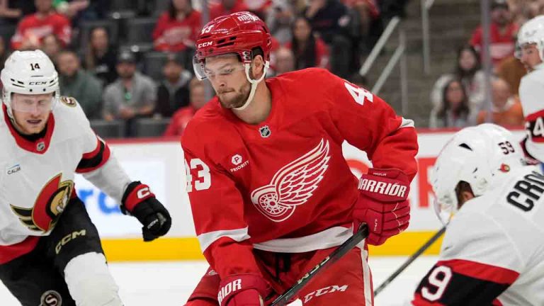 Detroit Red Wings left wing Carter Mazur (43) controls the puck next to Ottawa Senators left wing Angus Crookshank (59) during the first period of an NHL preseason hockey game, Friday, Oct. 4, 2024, in Detroit. (Carlos Osorio/AP)