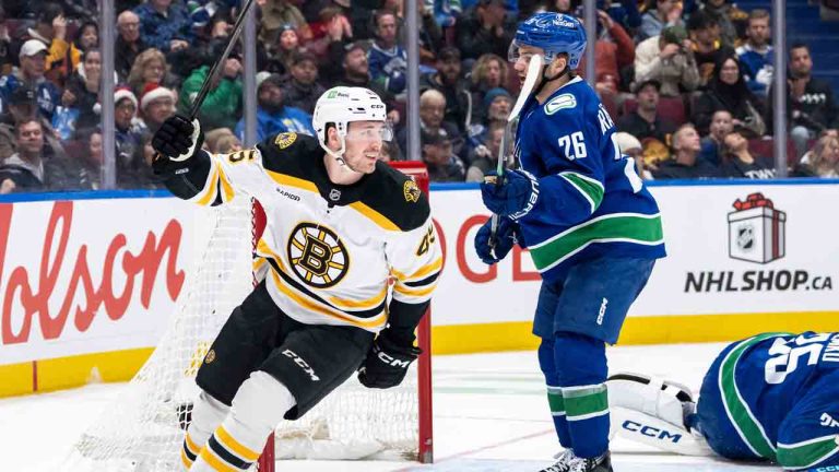 Boston Bruins' Cole Koepke (45) celebrates after Marc McLaughlin, not seen, scores on Vancouver Canucks goaltender Thatcher Demko (35) as Erik Brannstrom (26) watches during the second period of an NHL hockey game in Vancouver, B.C., Saturday, Dec. 14, 2024. (Ethan Cairns/CP)