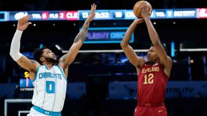 Cleveland Cavaliers forward De'Andre Hunter (12) shoots over Charlotte Hornets forward Miles Bridges (0) during the first half of an NBA basketball game in Charlotte, N.C., Friday, March 7, 2025. (Nell Redmond/AP)