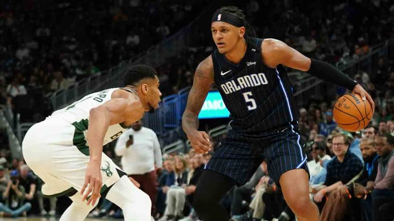 Orlando Magic's Paolo Banchero (5) drives to the basket against Milwaukee Bucks' Giannis Antetokounmpo during the first half of an NBA basketball game Saturday, March 8, 2025, in Milwaukee. (Aaron Gash/AP)