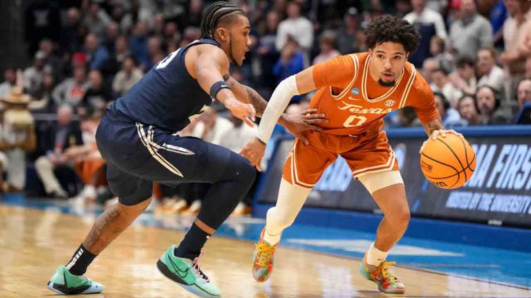 Texas guard Jordan Pope (0) drives against Xavier guard Dayvion McKnight during the first half of a First Four college basketball game in the NCAA Tournament, Wednesday, March 19, 2025, in Dayton, Ohio. (Jeff Dean/AP)
