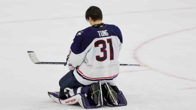 UConn goalie Callum Tung takes a moment to himself during an ice cleaning break while facing Quinnipiac during the first round of the NCAA college hockey tournament on Friday, March 28, 2025, in Allentown, Pa. (Jason E. Miczek/AP)