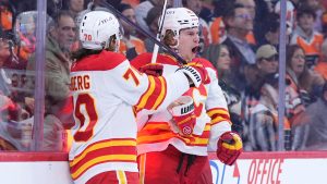 Calgary Flames' Connor Zary, right, and Ryan Lomberg celebrate after Zary's goal during the first period of an NHL hockey game against the Philadelphia Flyers Tuesday, March 4, 2025, in Philadelphia. (Matt Slocum/AP)
