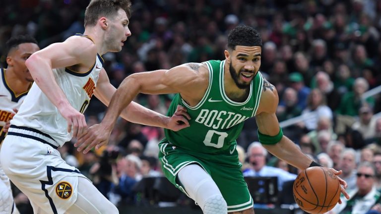 Boston Celtics forward Jayson Tatum, right, drives toward the basket past Denver Nuggets guard Christian Braun, front left, in the first half of an NBA basketball game, Sunday, March 2, 2025 in Boston. (AP Photo/Steven Senne)