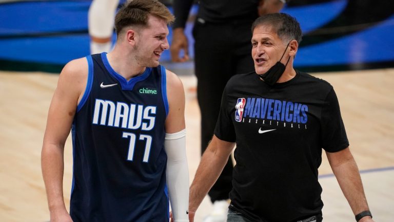 Dallas Mavericks guard Luka Doncic (77) smiles as he talks with team owner Mark Cuban as they walk off the court after the team's win in an NBA basketball game against the Detroit Pistons in Dallas, Wednesday, April 21, 2021. (AP Photo/Tony Gutierrez)