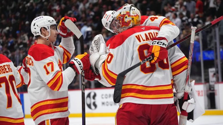 Calgary Flames goaltender Dan Vladar is congratulated by Calgary Flames right wing Adam Klapka and centre Yegor Sharangovich after a shootout in an NHL game against the Colorado Avalanche, Monday, March 31, 2025, in Denver. (AP/David Zalubowski)