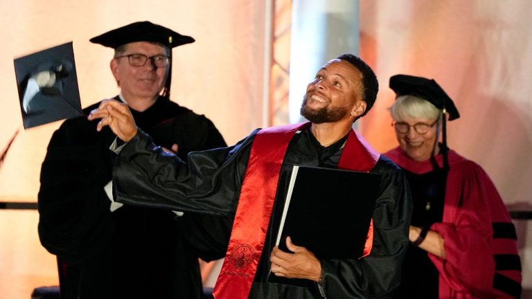 Golden State Warriors Stephen Curry tosses his cap in the air after his graduation ceremony at Davidson College on Wednesday, Aug. 31, 2022, in Davidson, N.C. (Chris Carlson/AP)
