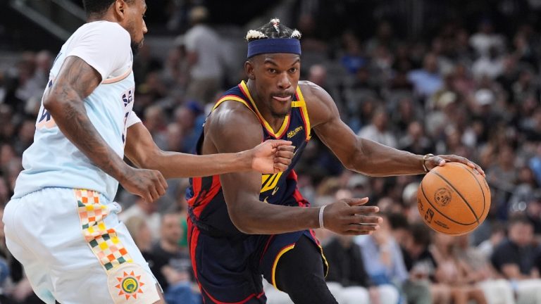 Golden State Warriors forward Jimmy Butler III, drives around San Antonio Spurs guard Blake Wesley, left, during the second half of an NBA basketball game in San Antonio, Sunday, March 30, 2025. (Eric Gay/AP)