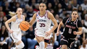 UConn guard Azzi Fudd (35) takes off with a steal as Arkansas State guard Shaunae Brown (0) chases during the first half in the first round of the NCAA college basketball tournament, Saturday, March 22, 2025, in Storrs, Conn. (Jessica Hill/AP)