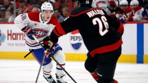 Montreal Canadiens' Lane Hutson (48) carries the puck to challenge Carolina Hurricanes' Sean Walker (26) during the first period of an NHL hockey game in Raleigh, N.C., Friday, March 28, 2025. (Karl DeBlaker/AP)