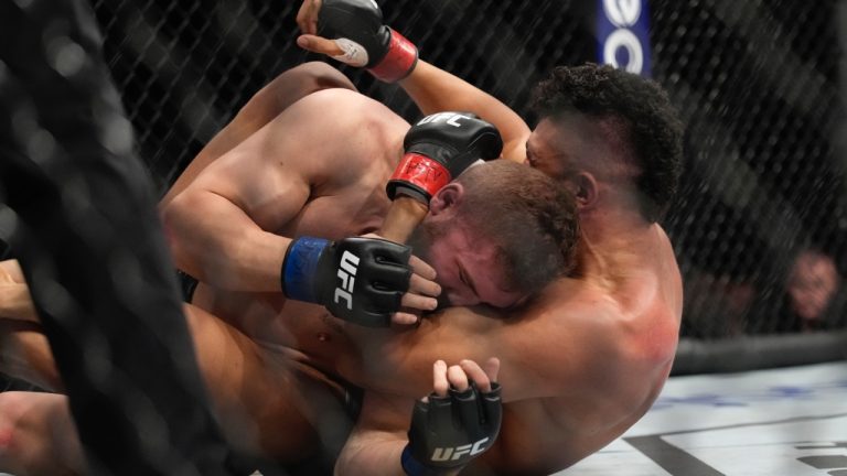 Ion Cutelaba seen here grappling with Johnny Walker in a light-heavyweight bout at UFC 279 in Las Vegas. (John Locher/AP)