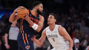 Dallas Mavericks' Dwight Powell (7) defends New York Knicks' Karl-Anthony Towns (32) during the second half of an NBA basketball game Tuesday, March 25, 2025, in New York. (AP Photo/Frank Franklin II)