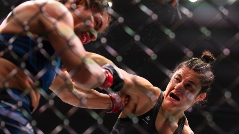 Loopy Godinez and Cynthia Calvillo fight during their women's straw weight title match during the UFC 287 event at the Kaseya Center on Saturday, April 8, 2023, in downtown Miami. (Matias J. Ocner/Miami Herald via AP)