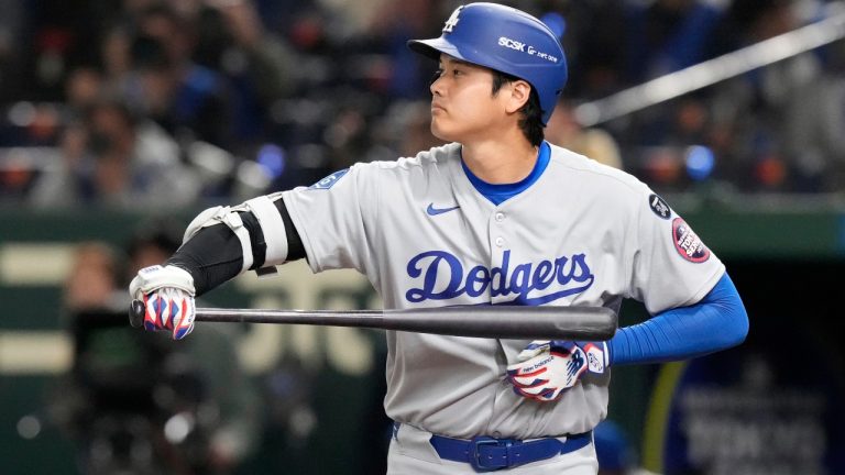 Los Angeles Dodgers' Shohei Ohtani wipes his bat during an at-bat in the sixth inning of an MLB Japan Series baseball game against the Chicago Cubs in Tokyo, Japan, Tuesday, March 18, 2025. (Eugene Hoshiko/AP)