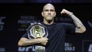 UFC light-heavyweight champion Alex Pereira poses with his belt during a UFC news conference. (Steve Marcus/Las Vegas Sun via AP)