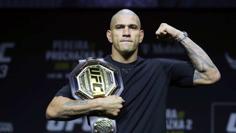 UFC light-heavyweight champion Alex Pereira poses with his belt during a UFC news conference. (Steve Marcus/Las Vegas Sun via AP)