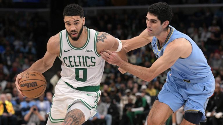 Boston Celtics forward Jayson Tatum (0) handles the ball against Memphis Grizzlies forward Santi Aldama in the second half of an NBA basketball game. (Brandon Dill/AP)