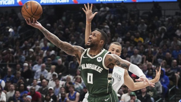 Milwaukee Bucks guard Damian Lillard (0) shoots as Dallas Mavericks' Dante Exum, rear, defends in the first half of an NBA basketball game in Dallas, Saturday, March 1, 2025. (Tony Gutierrez/AP)
