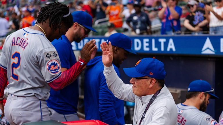 FILE - New York Mets owner, Steve Cohen, right, high fives Luisangel Acuña in the dugout after winning the game in the ninth inning of a baseball game against the Atlanta Braves, Monday, Sept. 30, 2024, in Atlanta. (Jason Allen/AP)