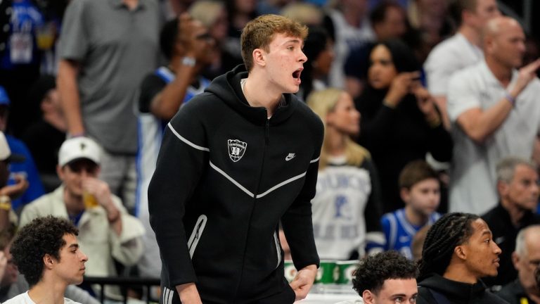 Duke forward Cooper Flagg watches from the bench during the first half of an NCAA college basketball game against North Carolina in the semifinals of the Atlantic Coast Conference tournament, Friday, March 14, 2025, in Charlotte, N.C. Flagg and was injured yesterday. (Chris Carlson/AP)