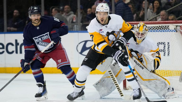 Pittsburgh Penguins' Vincent Desharnais, center, helps play defense with goaltender Alex Nedeljkovic, right, while New York Rangers' Vincent Trocheck, left, looks on during the third period of an NHL hockey game Friday, Feb. 7, 2025, in New York. (Seth Wenig/AP)