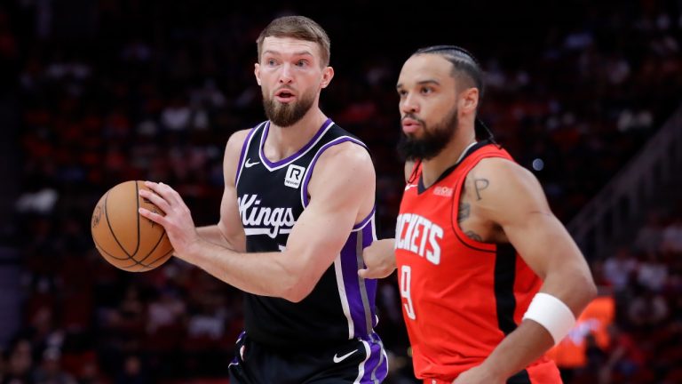 Sacramento Kings forward Domantas Sabonis, looks to pass the ball next to Houston Rockets forward Dillon Brooks, right, during the first half of an NBA basketball game, Saturday, March 1, 2025, in Houston. (Michael Wyke/AP)