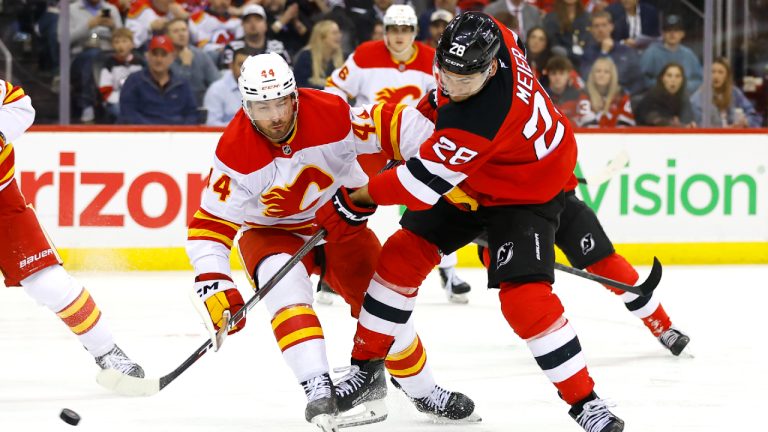 New Jersey Devils right wing Timo Meier (28) shoots the puck against Calgary Flames defenseman Joel Hanley (44) during the second period of an NHL hockey game, Thursday, March 20, 2025, in Newark, N.J. (Noah K. Murray/AP)