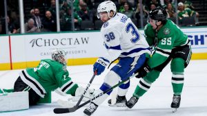 Tampa Bay Lightning left wing Brandon Hagel (38) shoots while defended by Dallas Stars defenseman Thomas Harley (55) during an NHL hockey game in Dallas, Thursday, March 20, 2025. (Gareth Patterson/AP)