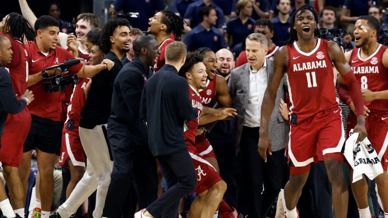 Alabama guard Mark Sears (1) celebrates with teammates and head coach Nate Oats after making a game-wining shot against Auburn in overtime of an NCAA college basketball game, Saturday, March 8, 2025, in Auburn, Ala. (Butch Dill/AP)