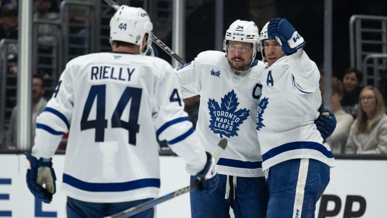 Toronto Maple Leafs center Auston Matthews (34), center John Tavares (91), and defenseman Morgan Rielly (44) celebrate the goal by Tavares during the third period of an NHL hockey game against the Los Angeles Kings, Saturday, March 29, 2025, in Los Angeles. (Kyusung Gong/AP)