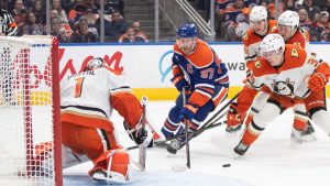 Anaheim Ducks goalie Lukas Dostal (1) makes the save on Edmonton Oilers' Connor McDavid (97) as Pavel Mintyukov (34) defends during second period NHL action in Edmonton on Tuesday, March 4, 2025. (Jason Franson/CP)