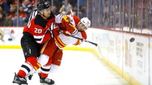 New Jersey Devils right wing Timo Meier (28) checks Calgary Flames defenseman Joel Hanley (44) during the first period of an NHL hockey game, Thursday, March 20, 2025, in Newark, N.J. (Noah K. Murray/AP)
