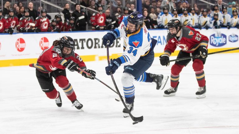 Toronto Sceptres' Hannah Miller (34) takes the shot as Ottawa Charge's Taylor House (22) tries to stop her during third period PWHL action in Edmonton, Sunday, Feb. 16, 2025. (Jason Franson/CP)