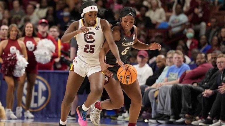 South Carolina guard Raven Johnson vies for a loose ball with Oklahoma forward Sahara Williams during the second half during of an NCAA college basketball game in the semifinals of the Southeastern Conference tournament. (Chris Carlson/AP)