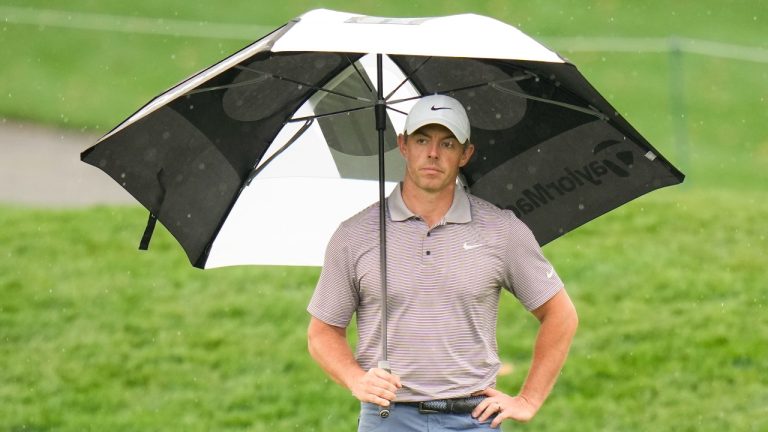 Rory McIlroy, of Northern Ireland, holds an umbrella on the 11th green during the final round of The Players Championship golf tournament Sunday, March 16, 2025, in Ponte Vedra Beach, Fla. (Chris O'Meara/AP)