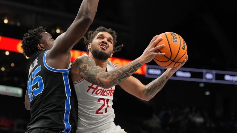 Houston's Emanuel Sharp (21) heads to the basket as Brigham Young's Fousseyni Traore (45) defends during the second half of an NCAA college basketball game in the semifinal round of the Big 12 Conference tournament, Friday, March 14, 2025, in Kansas City, Mo. (Charlie Riedel/AP Photo)