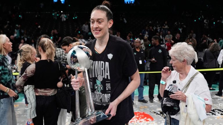 New York Liberty forward Breanna Stewart (30) holds the championship trophy after the Liberty defeated the Minnesota Lynx in Game 5 of the WNBA basketball final series, Sunday, Oct. 20, 2024, in New York. (Pamela Smith/AP)