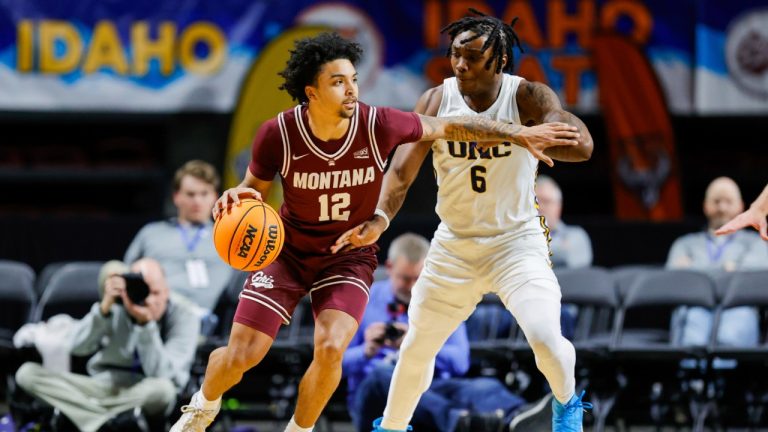Montana guard Brandon Whitney (12) works the ball around the defense of Northern Colorado guard Langston Reynolds (6) during an NCAA college basketball game in the championship of the Big Sky tournament, Wednesday, March 12, 2025, in Boise, Idaho. (Steve Conner/AP)